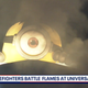 Universal Studios' giant Minion overlooks fire.